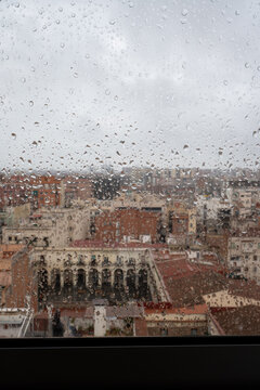 View through the rain-soaked window, Barcelona city skyline view