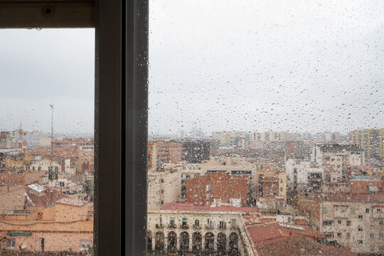 View through the rain-soaked window, Barcelona city skyline view