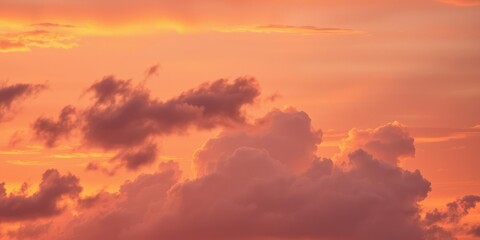 Obraz premium Warm hues and fluffy white clouds create a stunning sunset effect, calm mood, serenity