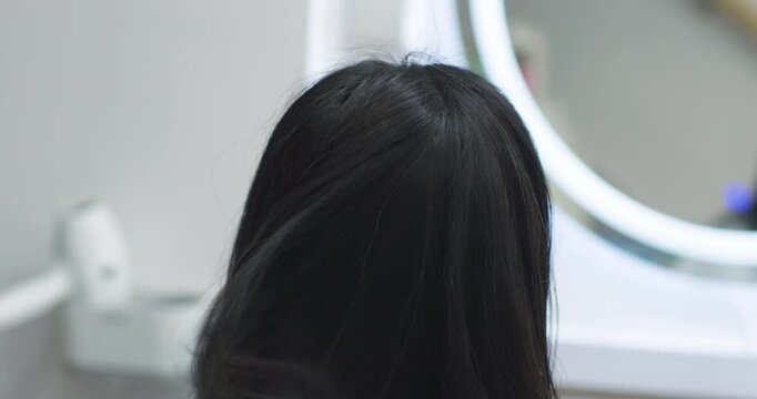 A Chinese woman getting her hair cut at a hair salon.