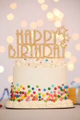 Tasty bento cake with colorful sprinkles and topper on table against light background, bokeh effect