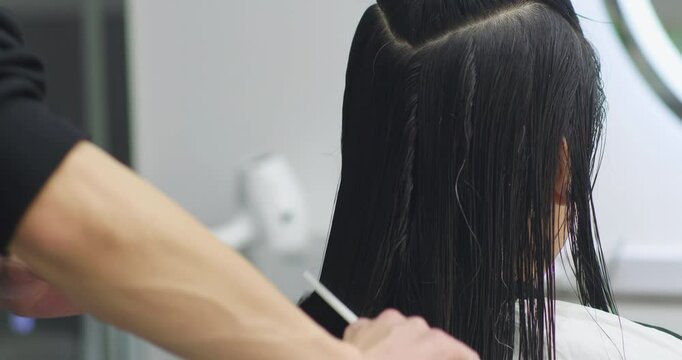 A Chinese woman getting her hair cut at a hair salon.