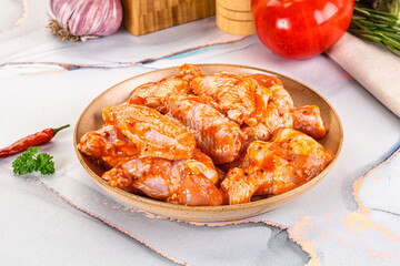 Raw marinated uncooked chicken wings