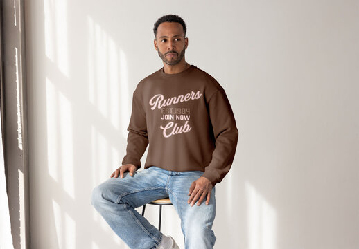 Mockup of a Black Man in a Sweater Looking Away Thoughtfully