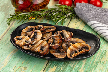 Tasty hot grilled champignon mushrooms