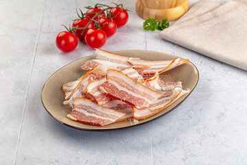 Raw pork tenferloin with bacon
