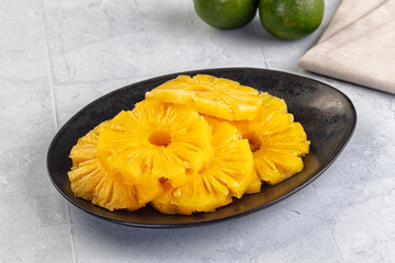 Sweet canned pineapple slices in syrope