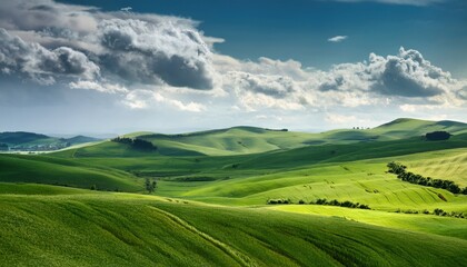 Fototapeta premium A breathtaking view of rolling green hills bathed in sunlight, with dramatic clouds casting shadows, creating a picturesque and tranquil countryside landscape.