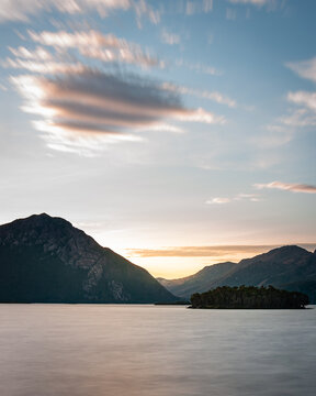 Dramatic Clouds Above a Rugged Mountain Range and Lake in Queenstown Tasmania
