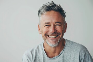 Obraz premium Portrait of a happy man in his 40s laughing in front of white background