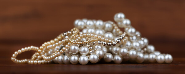 White and gold pearls, female jewelry necklaces. Wealth, luxury gift shopping background or banner.