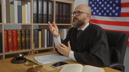 Hispanic male judge in an american courtroom, wearing a black robe with a beard and glasses,...
