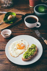 Toasts with mashed avocado and fried egg for breakfast
