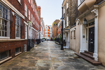 Quiet London Residential Street with Classic Brick Townhouses and Charming Architecture