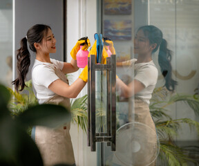 Professional cleaning service worker washing windows in office building