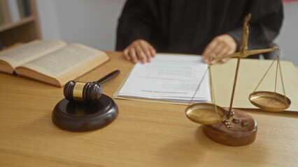 Judge in a courtroom setting with hands on legal documents and various legal objects like a gavel,...