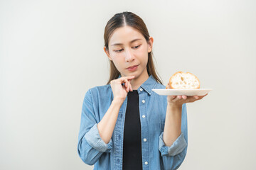 Gluten allergy, asian young woman hand covering mouth refusing to eat bread slice loaf on plate in...
