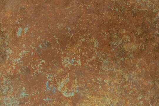 A close-up view of a rusted surface showcasing intricate textures and unique color variations.