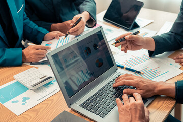 Business alliance groups by analyzing documents, discussing reports at the board meeting table. A...