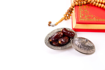 Taken in Denizli, Turkey. Date fruit, rosary and Quran on white background. It is sunnah to break the fast with dates in Ramadan.
