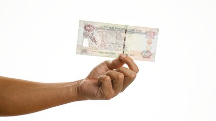 Man holding 500 dirham united arab emirates banknote isolated on white background