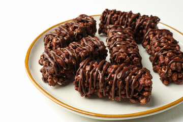 Delicious chocolate puffed rice bars on white table, closeup