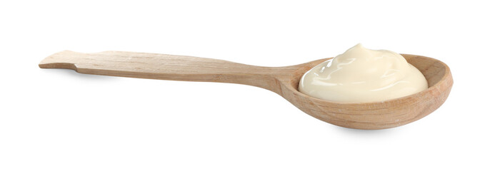 Tasty mayonnaise sauce in wooden spoon isolated on white