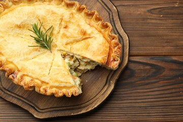 Delicious fresh homemade pie on wooden table, top view. Space for text