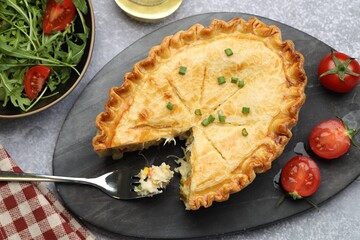 Delicious fresh homemade pie served on gray textured table, flat lay