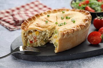 Delicious fresh homemade pie served on gray textured table, closeup