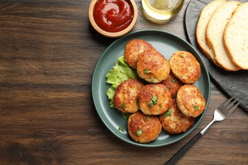 Delicious patties served on wooden table, flat lay. Space for text