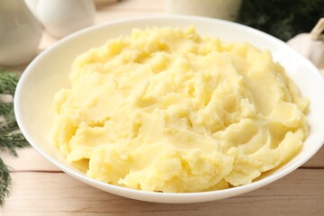 Delicious mashed potato on white wooden table, closeup