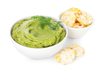Tasty avocado dip in bowl, dill and puffed rice cakes isolated on white