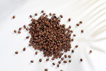 Fresh coffee beans in a mug and background.