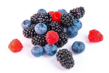 A bunch of fresh ripe berries raspberries, blueberries and blueberries on a white background.