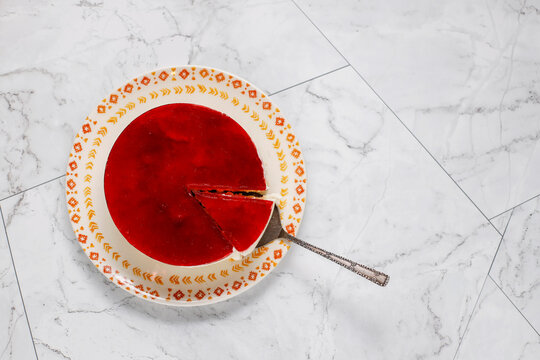 Delicious homemade cold cheesecake with red cherry jelly. - Powered by Adobe