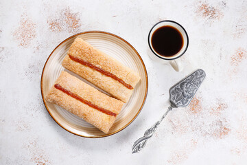 Homemade nut shaped russian soviet cookies and wafer rolls with pastry cream.