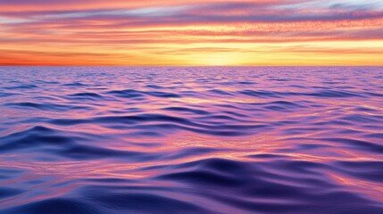 Obraz premium A tranquil ocean scene at sunset, featuring gentle waves reflecting vibrant hues of orange and purple in the sky, Ideal for use in relaxation, travel, or nature-themed projects,