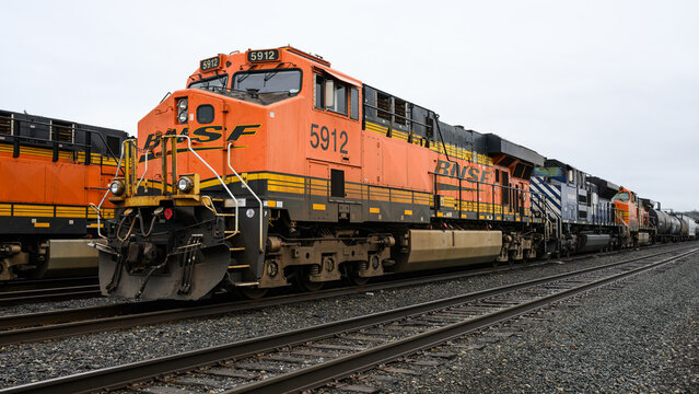 Seattle - February 23, 2025; BNSF mixed freight train with orange branded locomotive in closeup