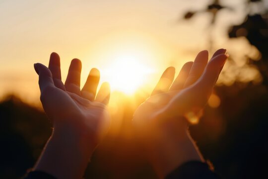 Hands reaching for the setting sun at golden hour: conveying hope and gratitude