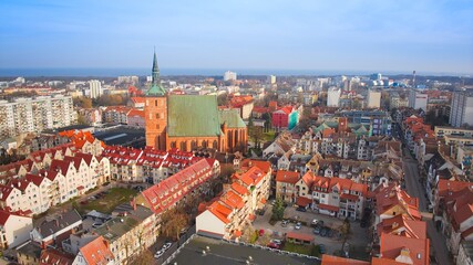 Aerial view of Kołobrzeg’s city center on a crisp March morning, featuring the majestic Basilica of the Assumption. © Grzegorz