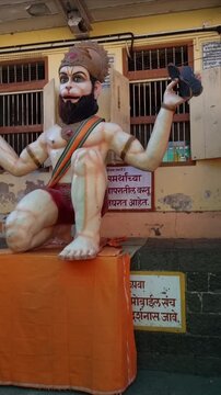 Hindu Lord Hanuman sitting in Lord Shri Ram prayer playing with musical instrument Kartal or Chipli with complete consciousness. Idol in Sajjangad Maharashtra built by Samarth Ramdas Swami.