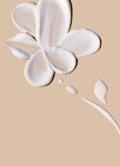 smears of creamy white texture cosmetic sample close up on beige background