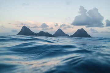 Calm Caribbean sea gently lapping against the shore, with the majestic Pitons of St. Lucia rising dramatically above the water at sunset