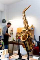 Saxophone standing on a stand in a musical instrument repair shop