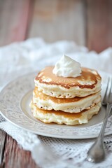 Fluffy Pancakes with Whipped Cream Topping on Elegant Plate