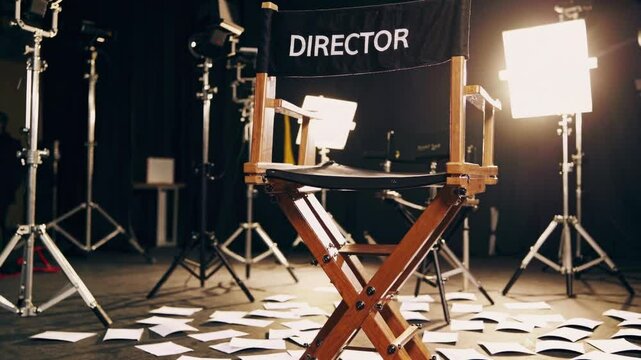 Director&rsquo;s chair on a film set with scattered scripts