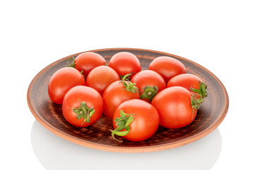 Juicy cocktail tomatoes on a clay plate, close-up, isolated on a white background.