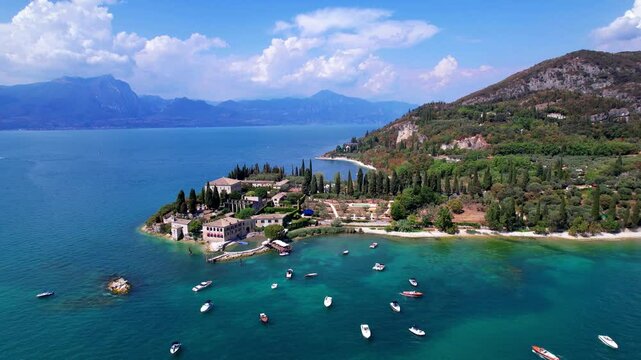 Italy Lake Garda Aerial 4K Video Drone View of Punta San Vigilio Romantic Peninsula with Historic Villa Harbor Baia delle Sirene and Cypress Trees Luxury destination Hidden gems