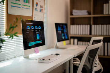 Professional workspace highlighting market research data on laptop, showing strategic business analytics with modern corporate environment